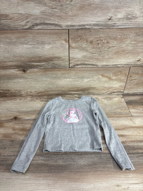 Gray long sleeve girls shirt with pink fairy graphic, laid flat on wooden floor