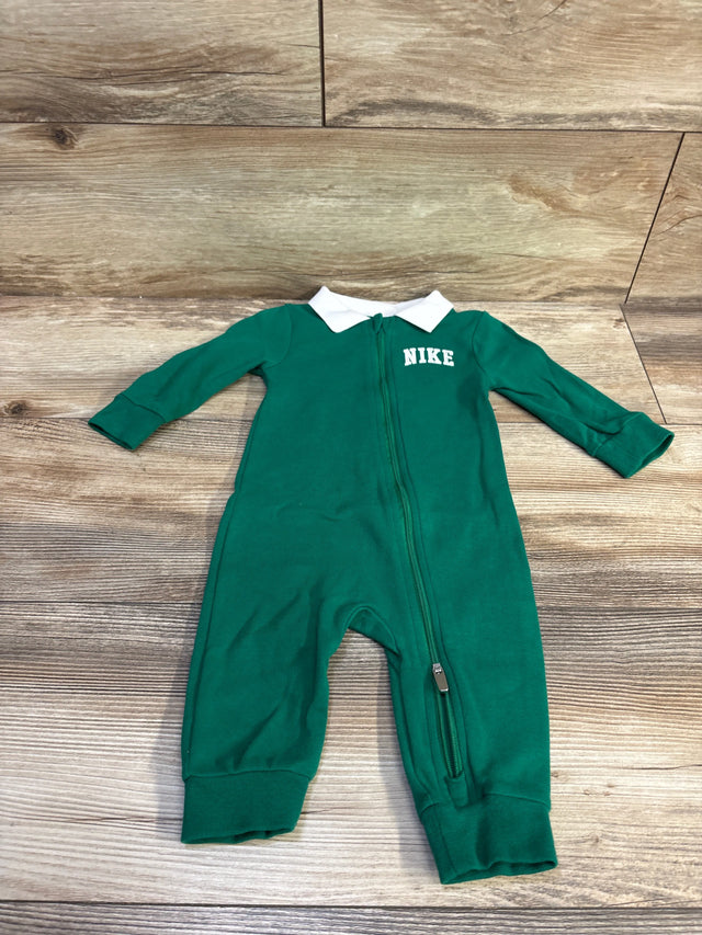 Green Nike collared zip coverall for infants in size 6m on a wooden background.