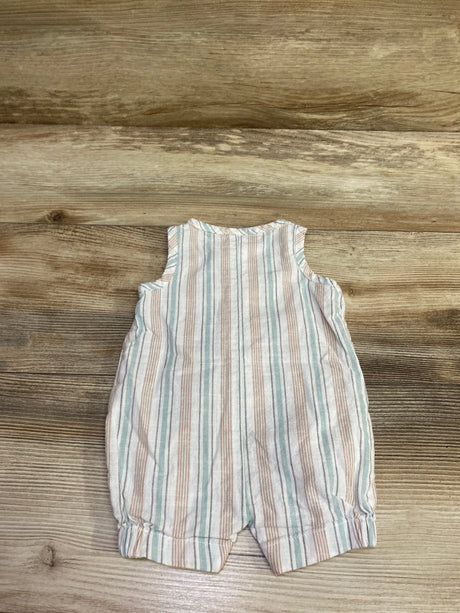 Front view of Just One You white striped henley romper showcasing blue and tan vertical stripes with a wood background