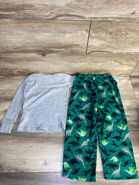 Kids long sleeve gray shirt and green dinosaur print pajama pants on wood background