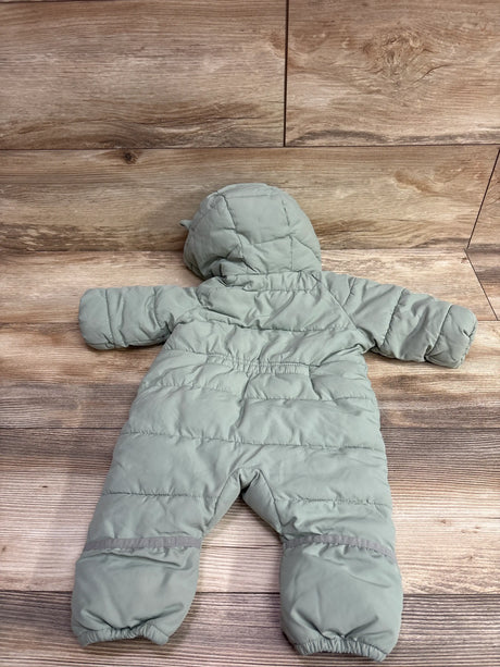Back view of green padded hooded bunting for 1 to 3 months on a wood surface