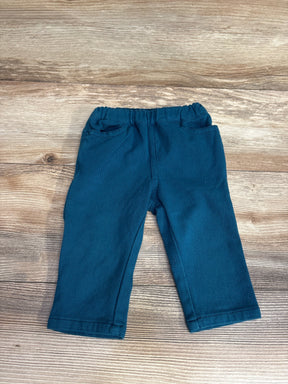 Teal toddler pants with elastic waistband on wood background, kids clothing resale
