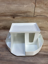 Front view of Dexbaby Spin changing station in white showing rotating base with four compartments and removable top tray on wood background