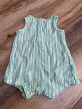 Green and white striped sleeveless baby romper with buttons, laid on wooden floor