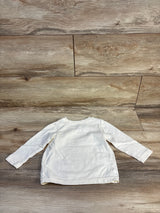 Back view of Disney Jumping Beans long-sleeve infant shirt (12M) showing plain beige back laid flat on wood floor