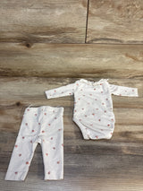 Baby girl floral long sleeve bodysuit and pants set on wooden background