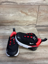 Angled front view of toddler Nike Air Max 270 Bred sneakers, black with red lining and white sole on wood background