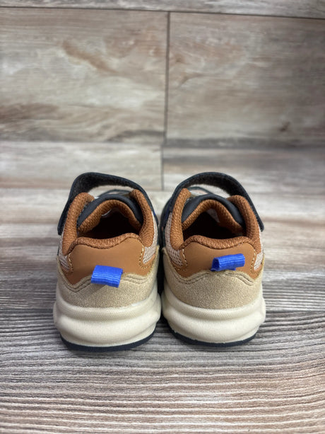 Rear view of Wonder Nation chunky jogger sneakers in brown, showing blue heel pull tabs and white soles on a wood surface
