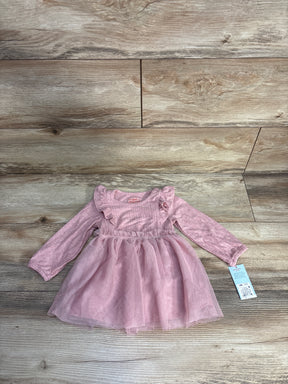 pink long-sleeve baby dress with ruffles and tulle skirt on wooden floor