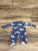 Blue Carter's newborn sleeper with white koala print on a wooden background