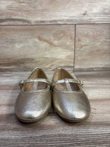 Front view of Susie T-strap ballet flats in metallic gold, size 8C, showing T-strap and rounded toe on wood background