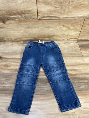 Flat lay of Art Class blue toddler drawstring jeans showcasing elastic drawstring waistband, stitched knee ribbing and faded wash on wood floor