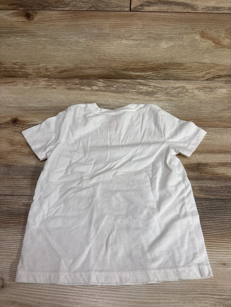 Back view of a Cat & Jack ivory seashell shirt in size 4T on a wooden surface.