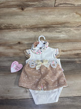Top view of white baby bodysuit with rose pink sequin shorts, satin bow and leopard print collar, matching headband on wood
