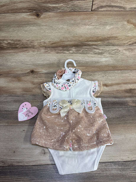 Top view of white baby bodysuit with rose pink sequin shorts, satin bow and leopard print collar, matching headband on wood