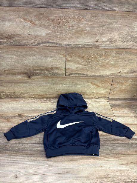 Front view of Nike navy pullover hooded sweatshirt size 18m with white swoosh and sleeve stripes on wood flooring