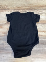 Black baby onesie with ruffled short sleeves on wood floor, kids clothing resale