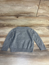 Gray kids sweater laid flat on wood floor, cozy knit long sleeve for children's wear