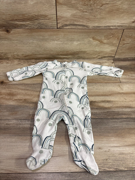White Kate Quinn organic footie sleeper with blue and green rainbow print on a wood background