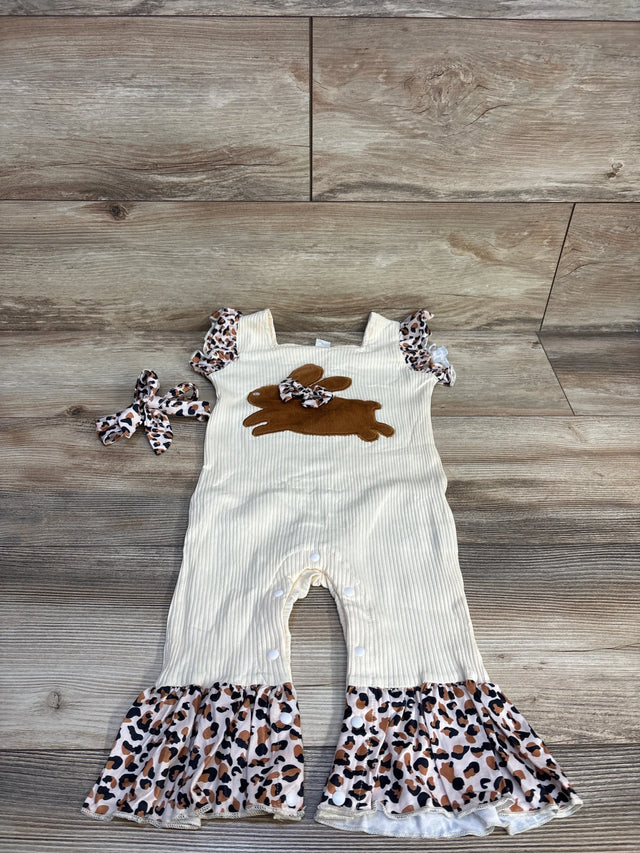 Baby girl cream romper with ruffle leopard print trim and matching headband on wood background