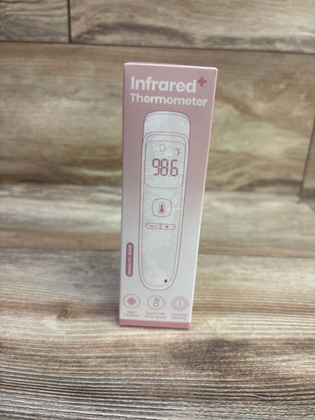 Front view of NEW SUWU No-Touch Infrared Thermometer in pink packaging showing a digital temperature display on a wood-grain background