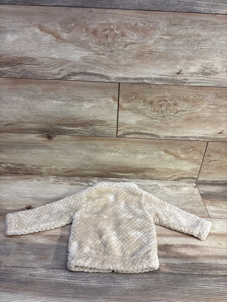 Back view of Columbia Fire Side Sherpa full-zip baby jacket showcasing beige sherpa texture and long sleeves on wood plank background