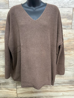Brown V-neck knit sweater with long sleeves on black mannequin against wood background