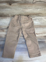 Light brown toddler pants with back pockets on a wood background, kids clothing resale