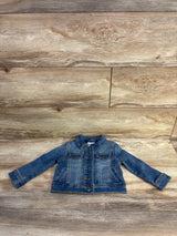 Flat-lay front of Cat and Jack blue denim jacket showing buttons, chest pockets and cuffed sleeves on wood background