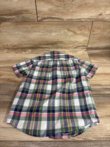 Back view of toddler poplin button-down shirt in green and pink plaid, short-sleeve with curved hem on wood background