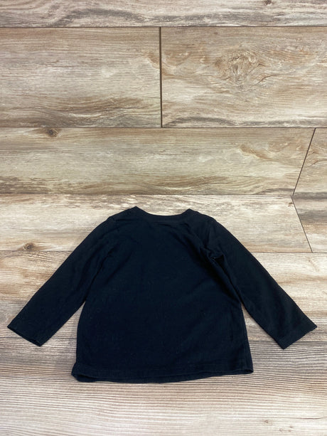 Front view of Cat & Jack black long sleeve shirt in size 2T showcasing its plain design on a wood-patterned background