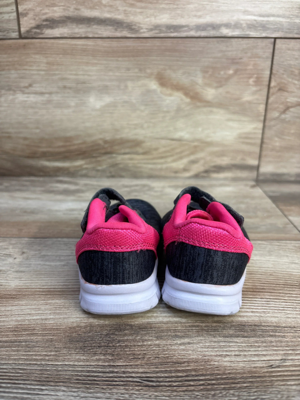 Back view of Champion Gusto toddler sneakers (size 3C) showing grey knit upper, pink heel trim, and white sole on wood background