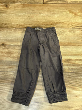 Gray toddler cargo pants with elastic waist and cuffs on wood background