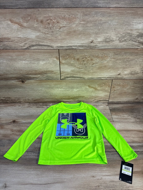 Front view of boys' Under Armour long-sleeve performance shirt in hyper green with blue logo and field graphic on wood background