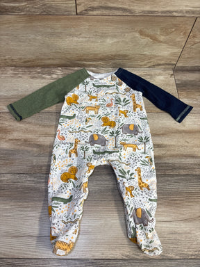 Baby sleeper with safari animal print, green and navy sleeves on wood floor
