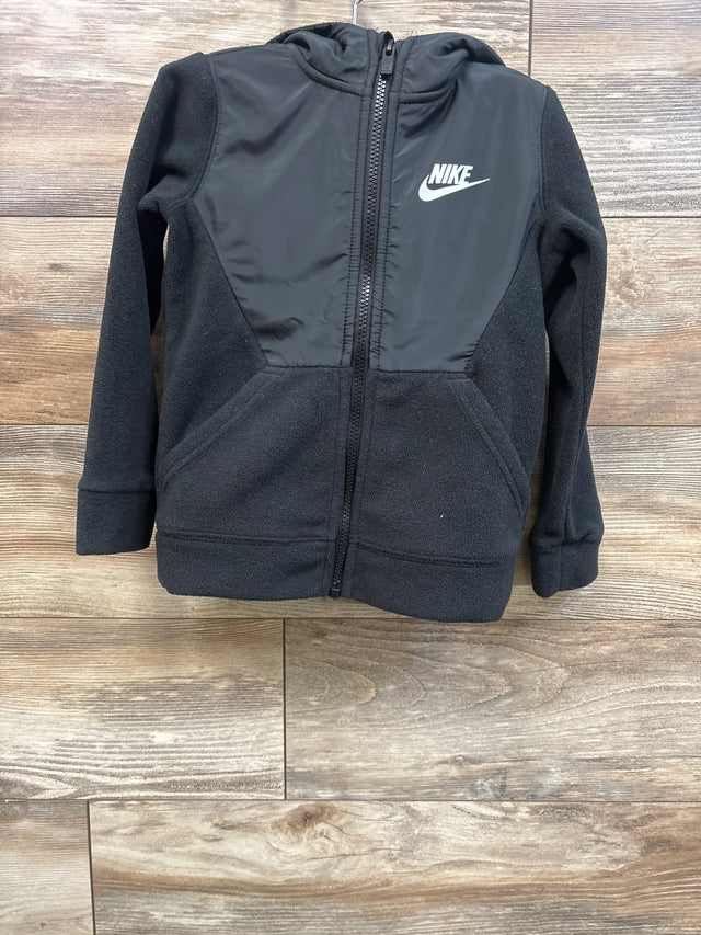 Front view of black Nike Sportswear full-zip fleece jacket, size 4-5T, showing Nike logo and zippered front on wood floor