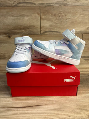 Pair of white and pastel blue Puma high-top sneakers on red Puma shoe box on wooden surface