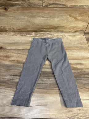 Front view of Old Navy glitter leggings in grey, size 2T showcasing the glitter finish on a wood background