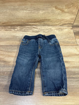 Front view of Baby Gap pull-on straight baby jeans in blue showing ribbed elastic waistband with drawstring and faded wash on wood floor