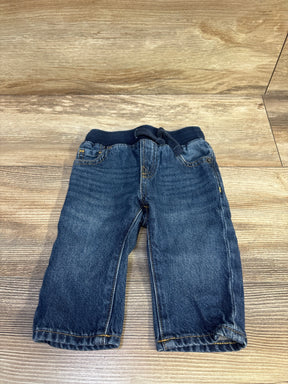 Front view of Baby Gap pull-on straight baby jeans in blue showing ribbed elastic waistband with drawstring and faded wash on wood floor