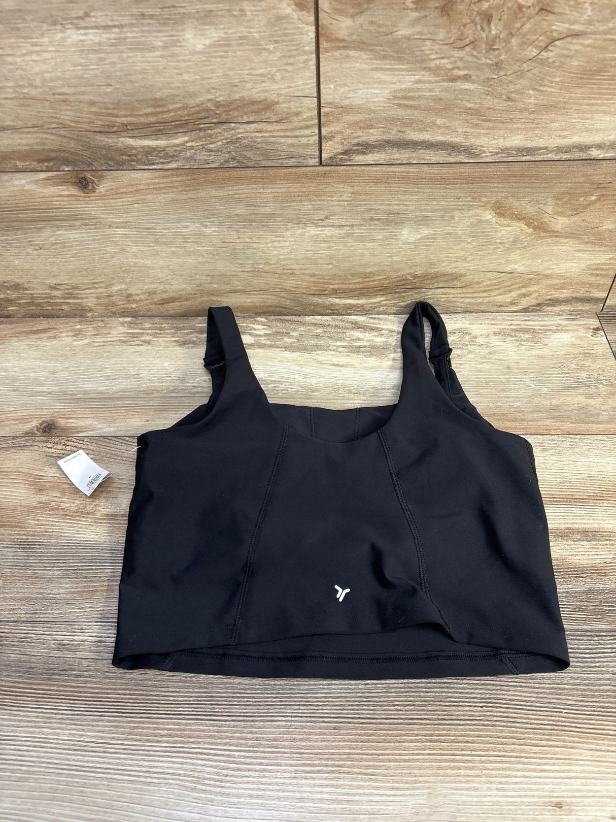 Front flat-lay of Old Navy nursing sports bra showing wide straps with nursing clip and longline band on wood background