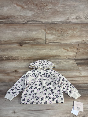 White toddler hoodie with black and light purple leopard print laid on wooden floor
