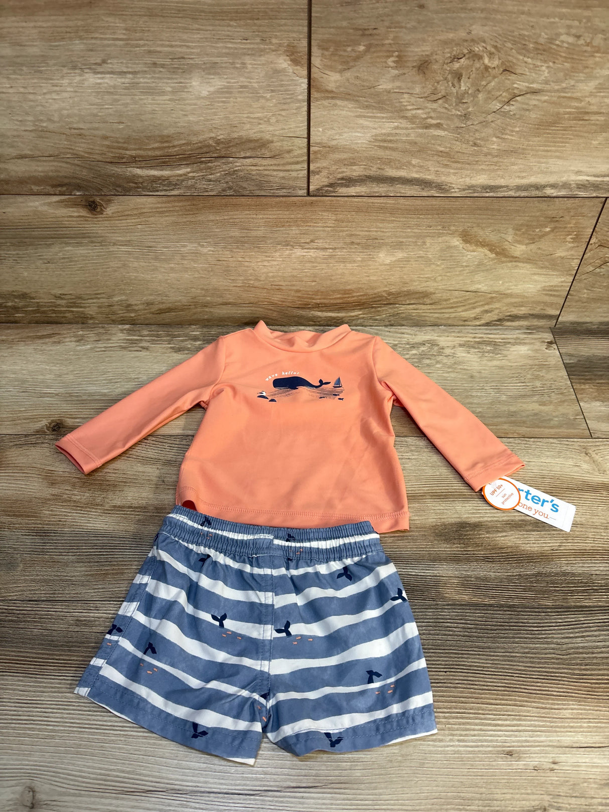 Toddler swimsuit set with coral long-sleeve rash guard and whale print swim trunks