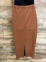 Front view of brown ribbed maternity skirt with elastic waistband and center slit against wood plank background