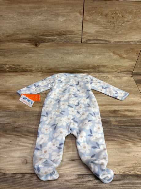 Front view of a blue floral Just One You blanket sleeper showcasing long sleeves and footed legs on a wood floor
