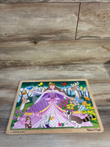 Top-down view of Melissa and Doug 24-piece wooden jigsaw puzzle featuring a princess with animals and flowers on a wood floor