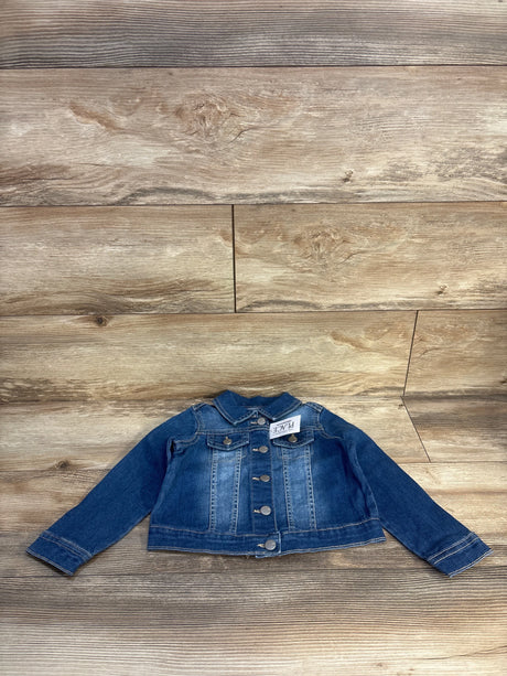 Toddler denim jacket with front buttons and pockets on wood background