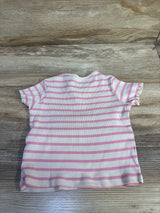 Top-down view of H&M 3T ribbed short-sleeve shirt, beige with pink horizontal stripes and lettuce-edge sleeves on wood background