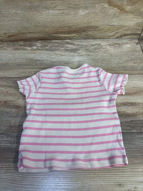 Top-down view of H&M 3T ribbed short-sleeve shirt, beige with pink horizontal stripes and lettuce-edge sleeves on wood background