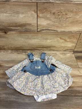 Floral baby romper dress with denim overall top on wood background